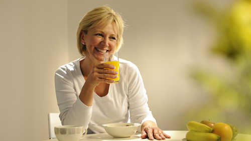 older woman eating breakfast foot