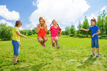 Girls jumping over the rope with friends