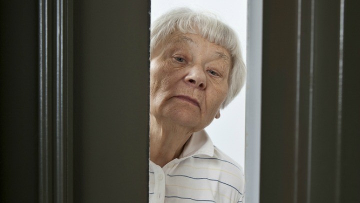 79584904_mature_woman_answer_door Shutterstock