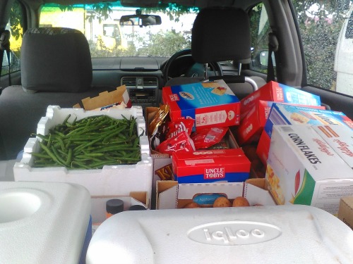 Things like breads and produce from food banks loaded into the car, ready for distribution. Photo courtesy of Alan.