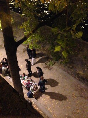 Evening along the Seine -- a group of young people enjoying a lamp-lit meal al fresco. Courtesy Catherine Urbanski