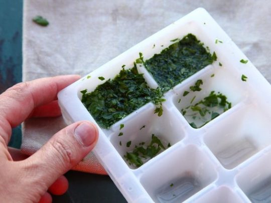 Chop the herbs up, stuff them into the ice trays and soak with olive oil. Store in the freezer until you need to use them.