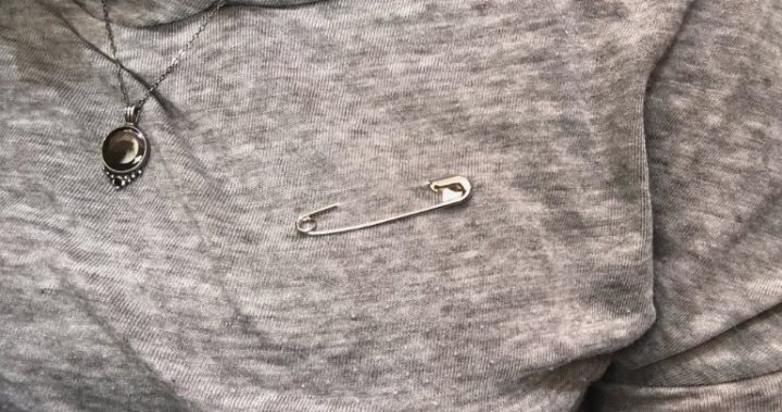 people are wearing safety pins as a sign of solidarity