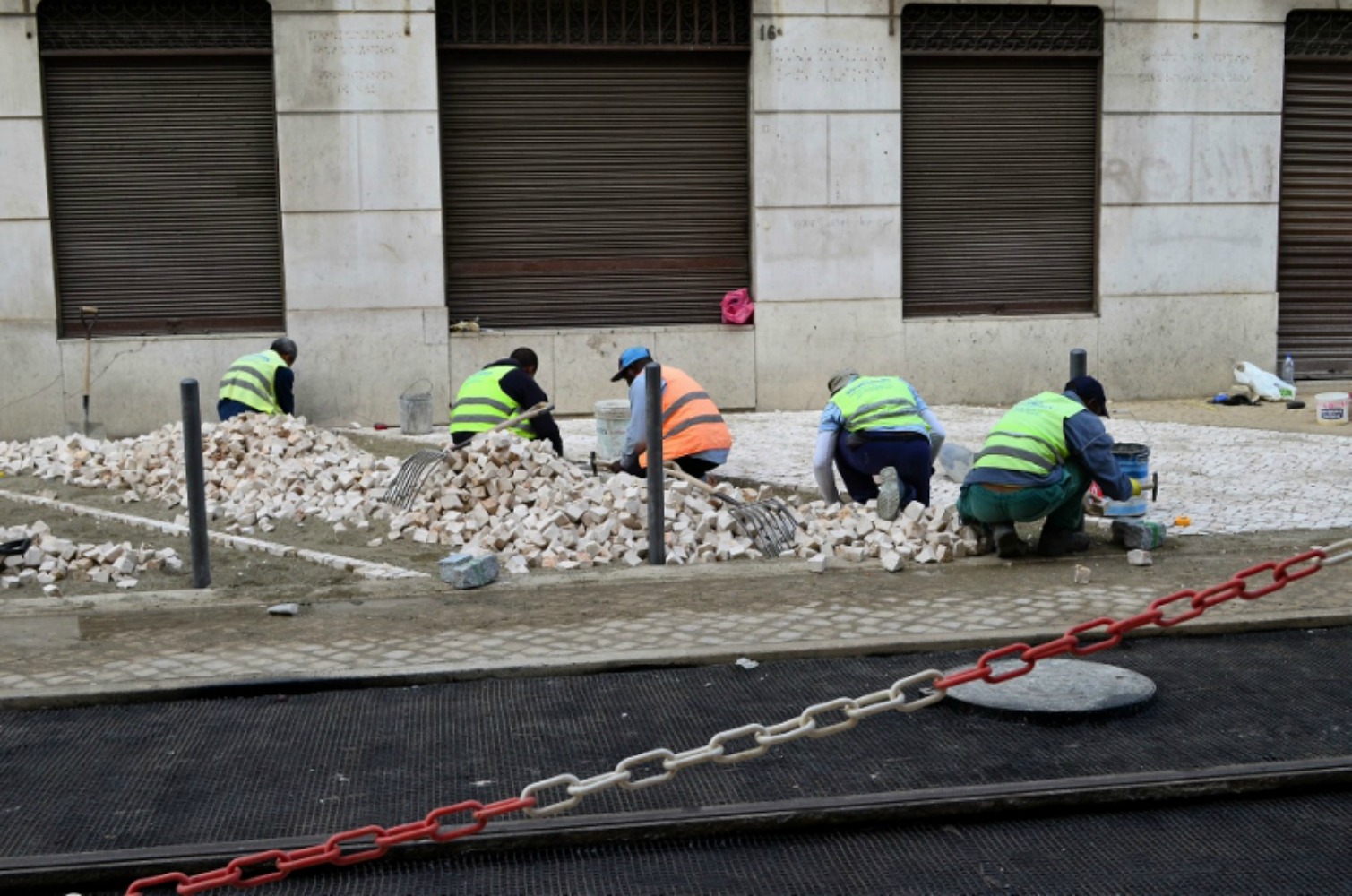 Teams working on laying the intricately designed cobblestones. Photo courtesy Lorraine Parker.