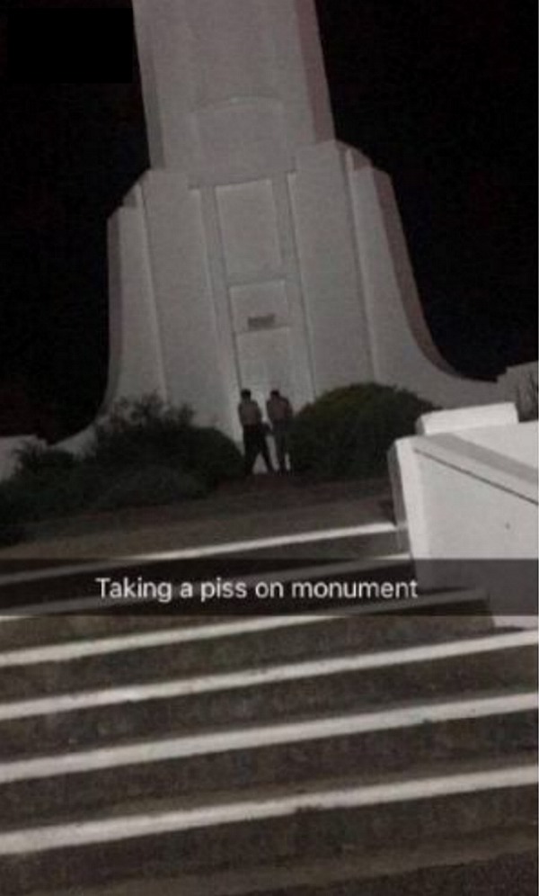 Two men were pictured urinating against the war memorial. 