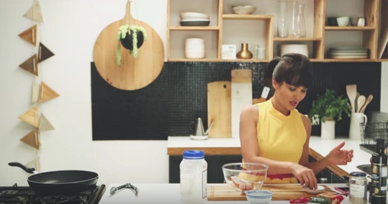 Yumi whips up a dish in the kitchen. 