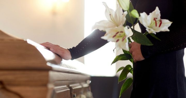 joke 287 Person holding flowers near casket