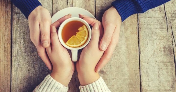 tea hands hands around a cup of tea