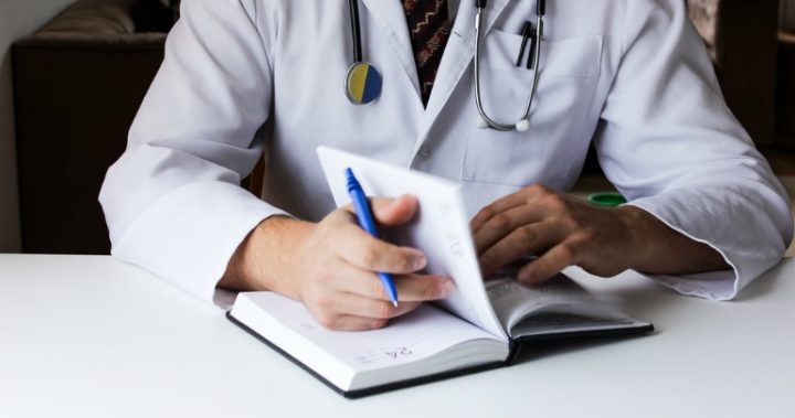 814 doctor with notebook and stethoscope