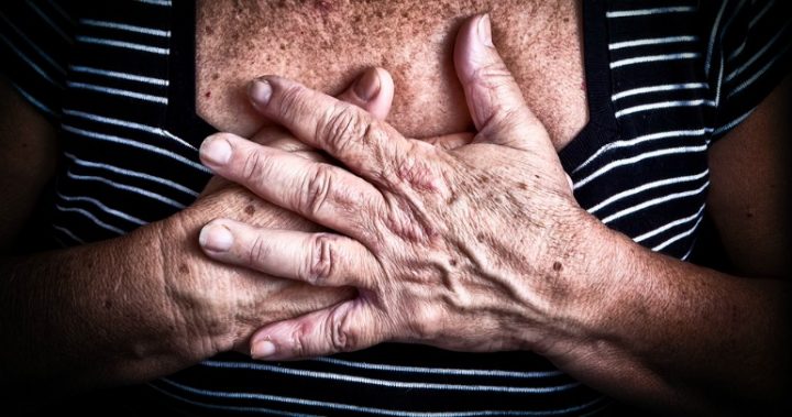 heartburn woman's hands over chest