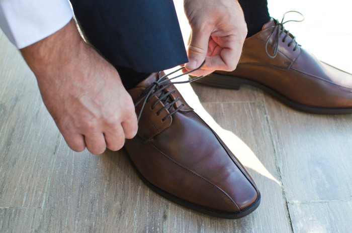 man tying up shoes