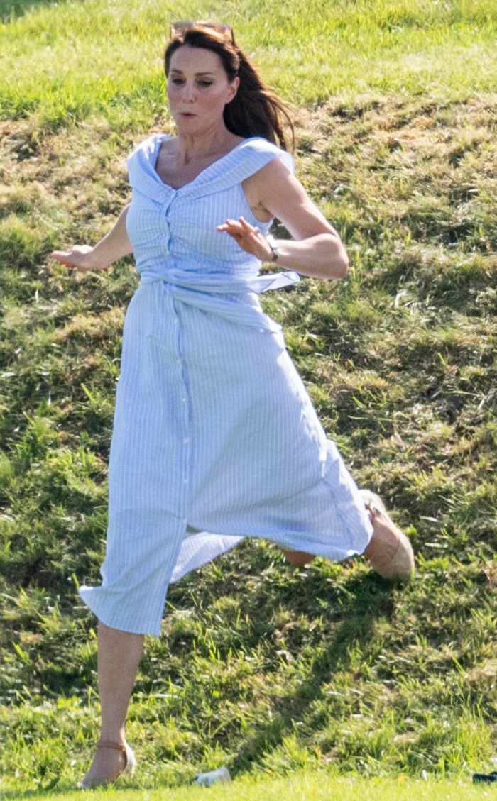 Low-heeled wedges and a casual dress meant Catherine had no problem bounding down the hill after Prince George. Source: Mark Cuthbert/UK Press via Getty Images