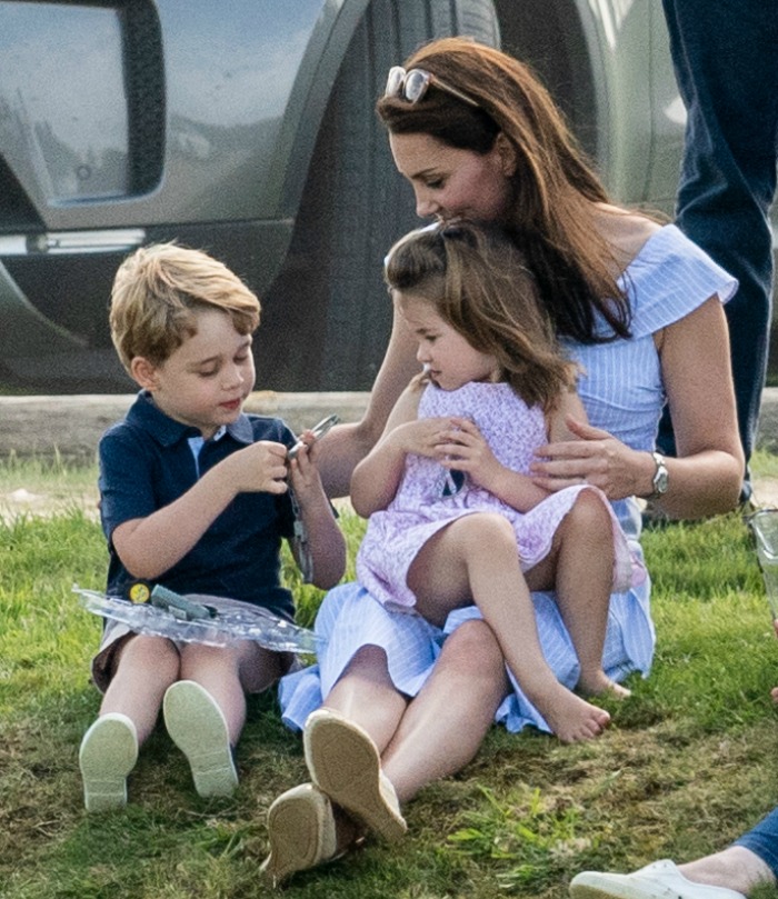 The Duchess of Cambridge was like any mum on a day out, with small children lounging all over her! Source: Mark Cuthbert/UK Press via Getty Images