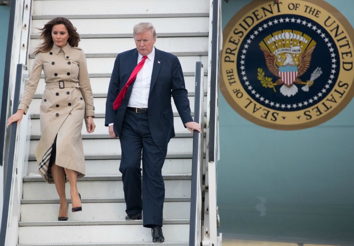 Melania Trump opted for a beige trench coat and classic black Louboutin pumps on her arrival in Brussels.