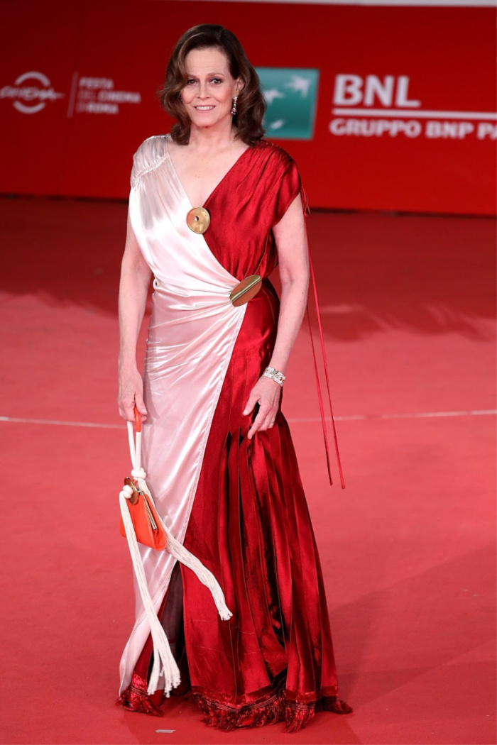 Sigourney Weaver looked fabulous in a floor-length red and pink gown.