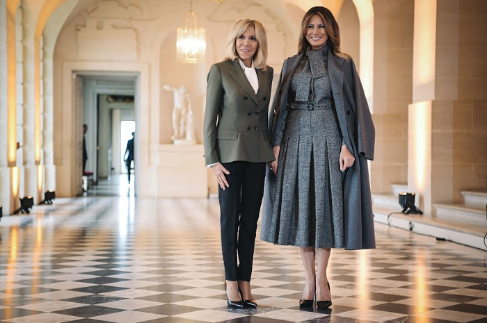 The French President's wife and US First Lady Melania Trump pose during an event at the Chateau de Versailles in Paris as part of commemorations marking the 100th anniversary of the end of World War I.