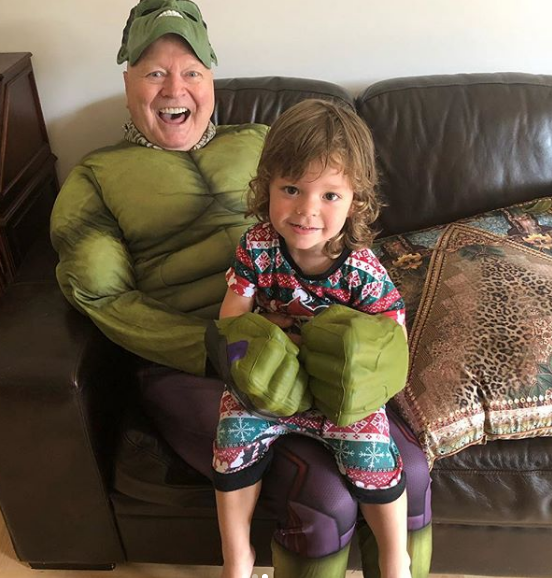 Bert Newton, dressed as the Hulk, sits with his grandson Monty at his third birthday party. 