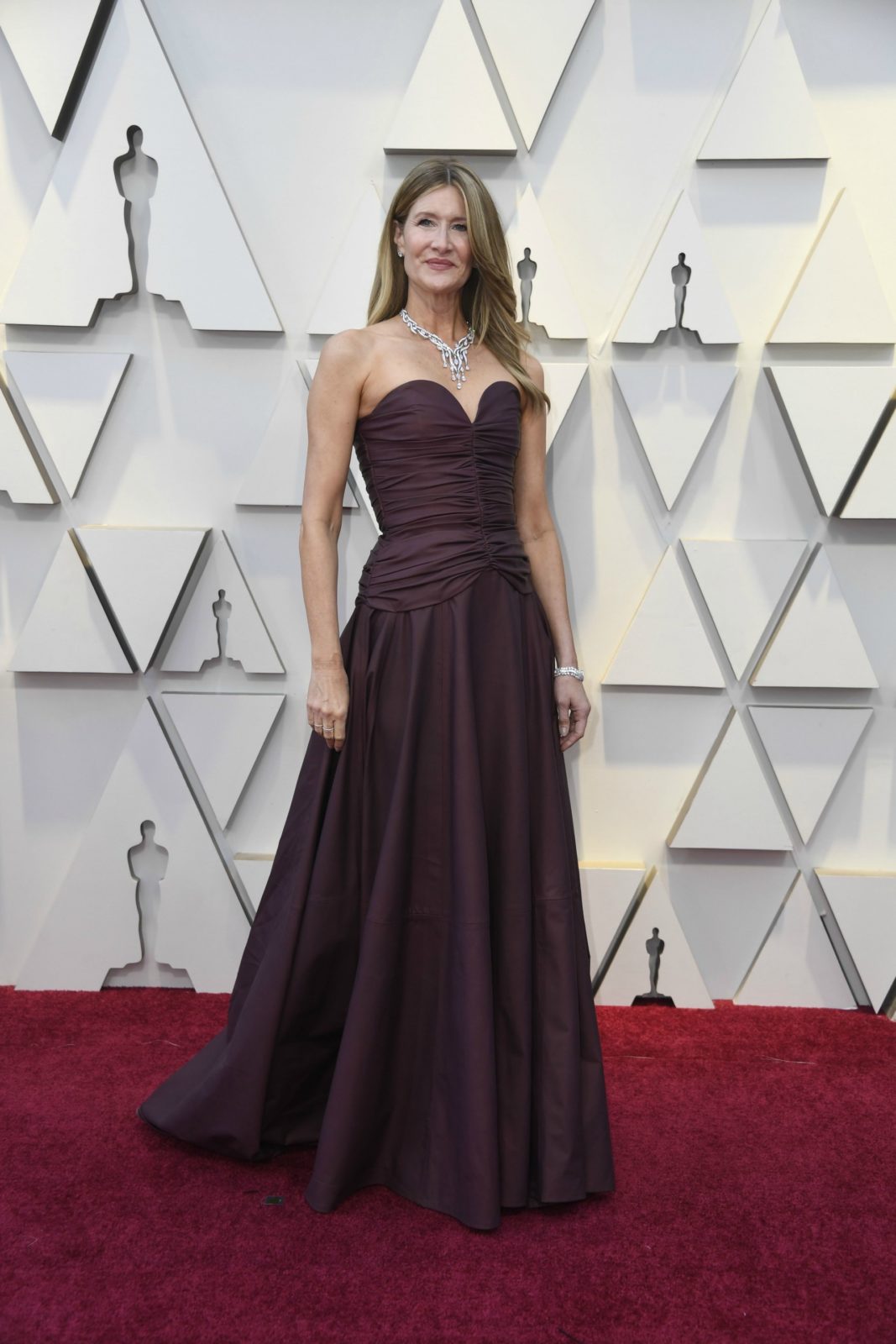 Laura Dern commanded attention in a burgundy strapless gown. Source: Getty