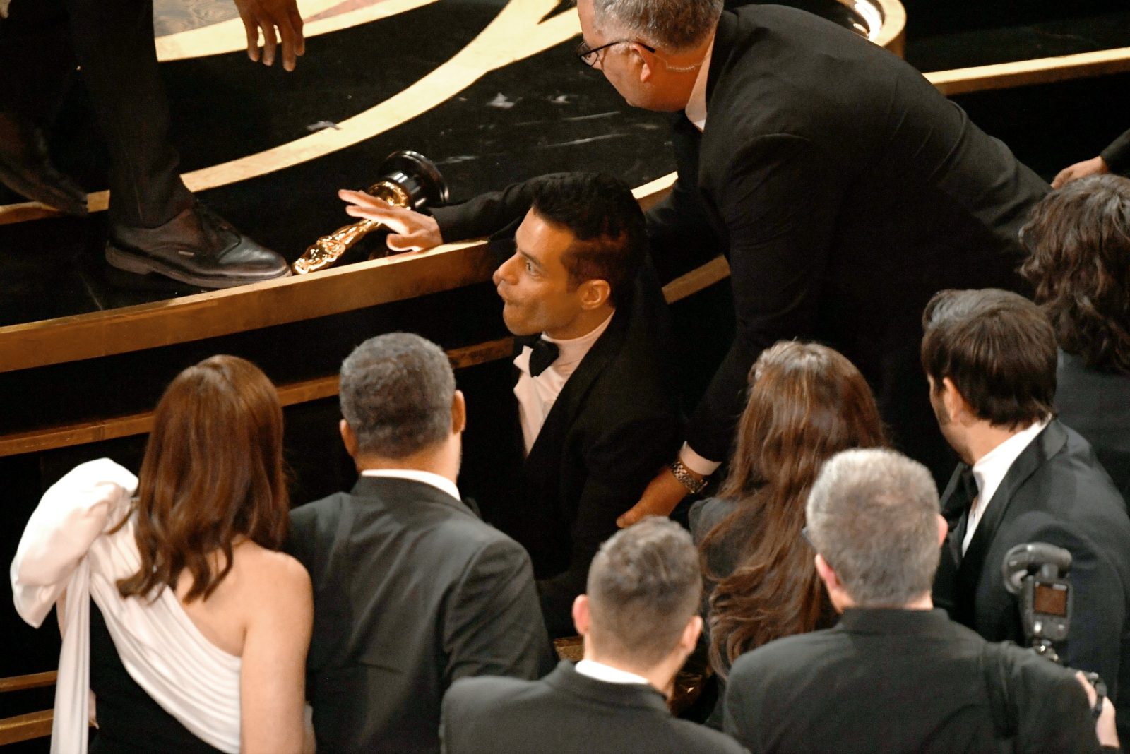 Rami Malek falls off stage at the Oscars.