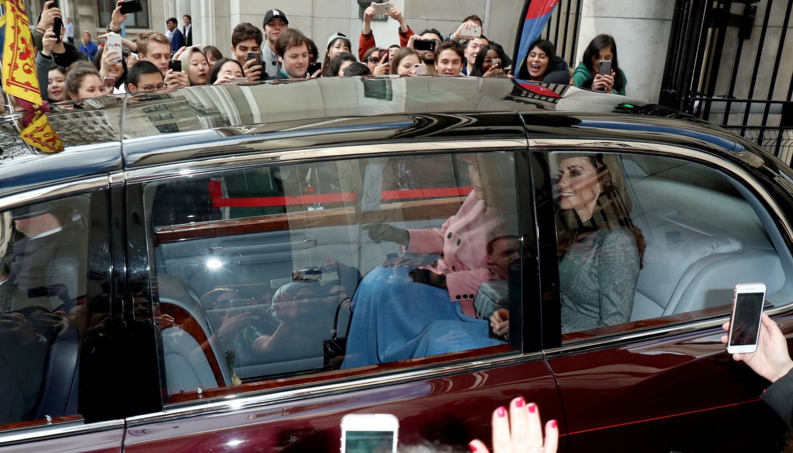 Catherine and the Queen shared a blanket together in the back seat. Source: Getty.