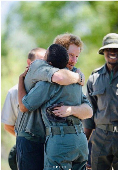 Prince Harry hugs an environmental worker in Botswana.