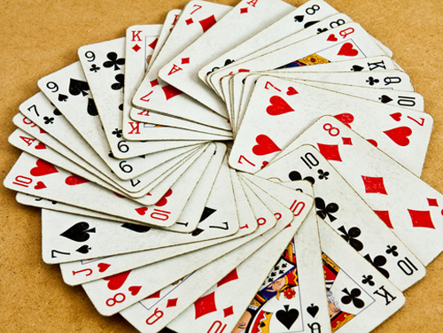 Old deck of playing cards on a wooden table